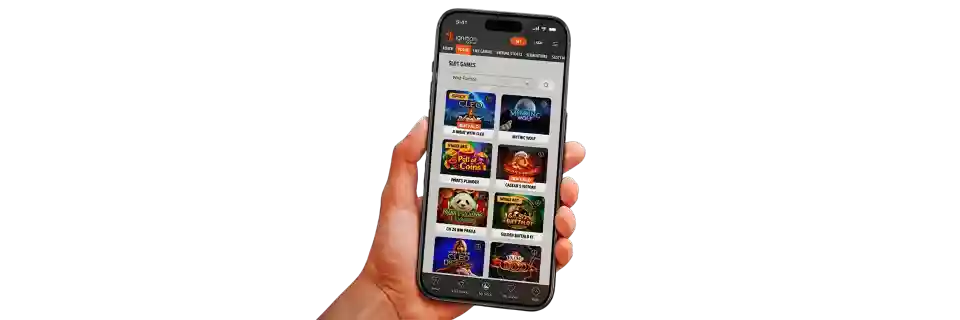 Hand holding a smartphone displaying the Ignition Casino mobile app slot games menu